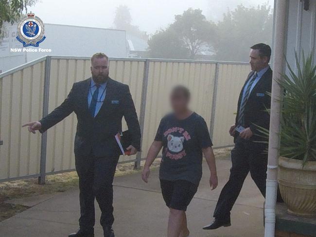 Tracey Gould is escorted from her home after a police raid. Picture: NSW Police