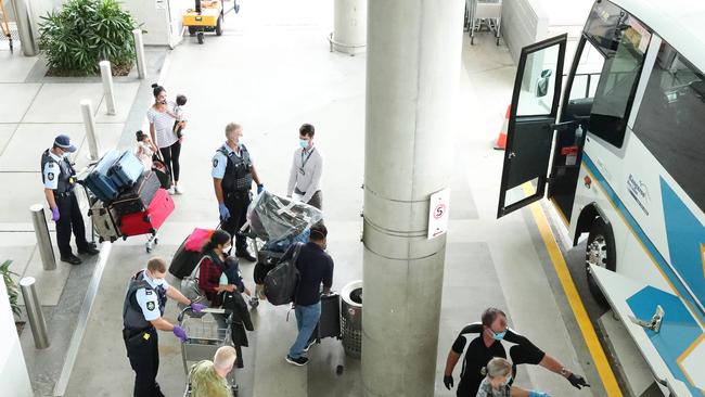 The first flight from New Zealand arrives at the Brisbane International Airport. All of the passengers were taken to a bus for hotel quarantine. Photographer: Liam Kidston