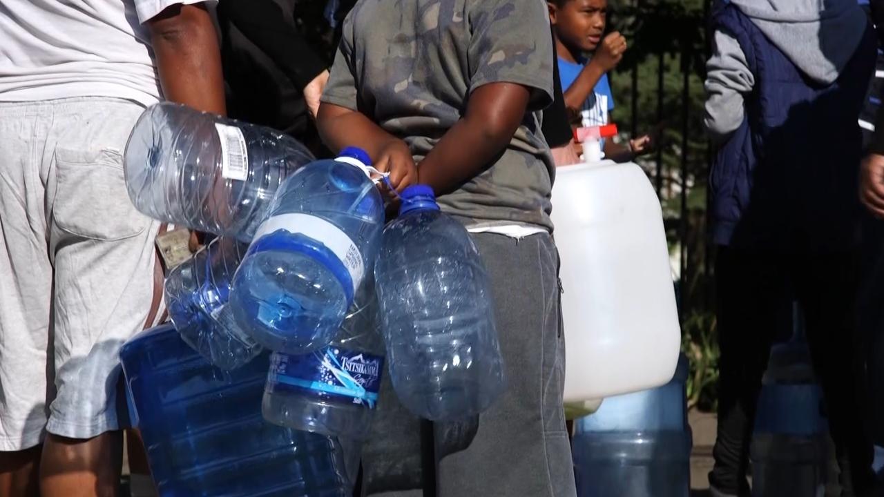 Residents filling up at natural springs. Picture: SBS