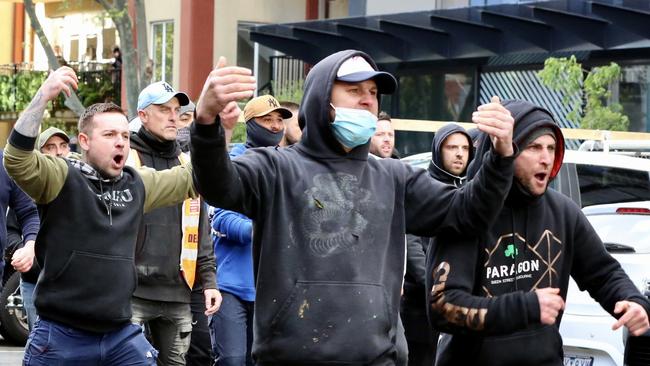 Police pictured clashing with protesting workers at the CFMEU headquarters in Melbourne.