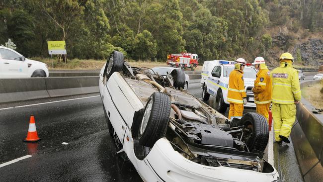 A vehicle that was flipped going uphill, southbound on the Southern Outlet in the wet weather. Picture: MATHEW FARRELL