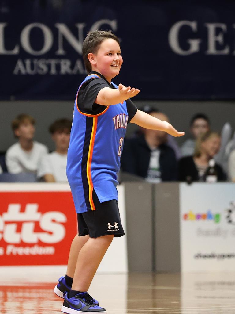 GEELONG, AUSTRALIA - OCTOBER 30: A young fan pumps up the crowd at 3/4 time during the round one WNBL match between Geelong United and Townsville Fire at The Geelong Arena, on October 30, 2024, in Geelong, Australia. (Photo by Kelly Defina/Getty Images)