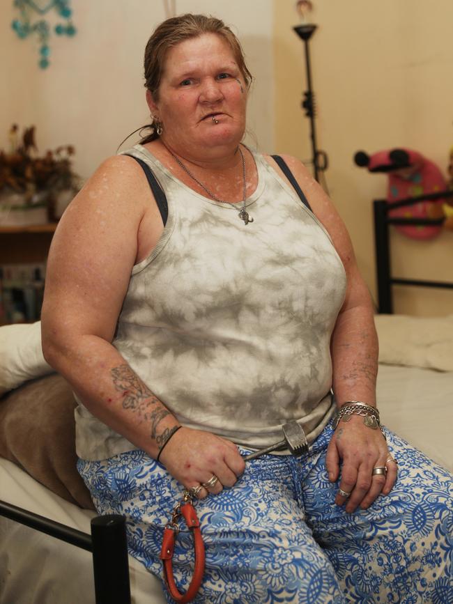 Belinda Marriott holding a meat tendering hammer she keeps for protection. inside her unit in a housing commission complex 7-5 Levitt street dubbed “The Ice Palace“ Wyong, where a murder was discovered in a neighbouring apartment last week. Picture John Grainger