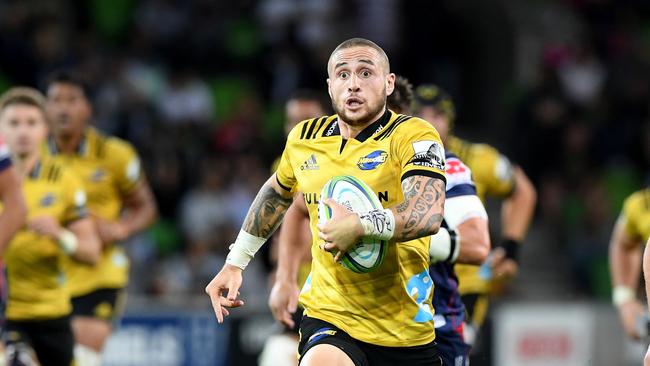 TJ Perenara runs the ball for the Hurricanes.