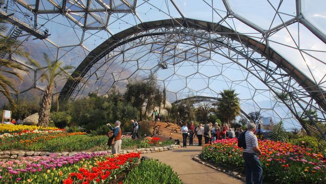 OVERSEAS: Visitors walk among the flowers inside one of the biodomes at the Eden Project near St Austell, England. Photo: Matt Cardy/Getty Images