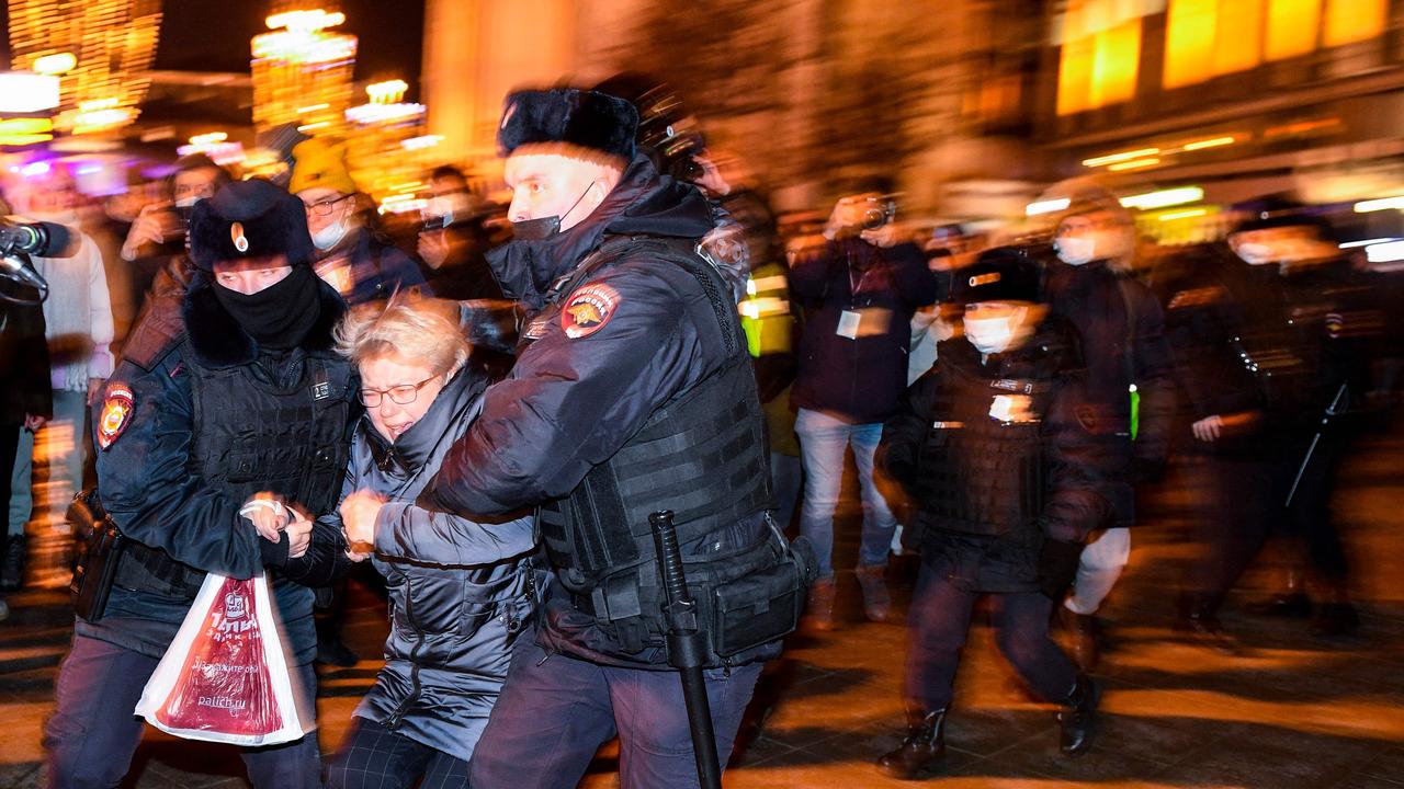 A woman is pulled away by police. Picture: Kirill KUDRYAVTSEV / AFP