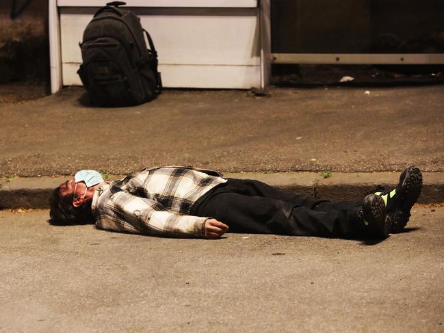 A man wearing a protective mask collapses in Rome. Picture: Getty