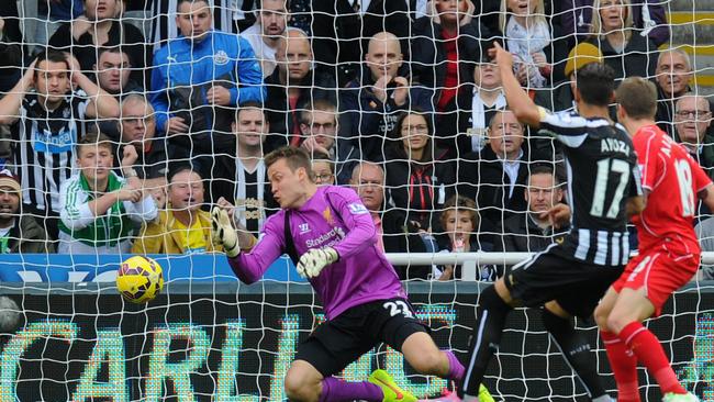 Newcastle player Ayoze Perez squeezes it past Simon Mignolet.