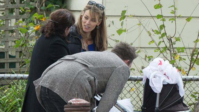 Kat Stewart and Eddie Perfect, pictured on the set of Offspring in Melbourne, where Stewart introduced her co-star Perfect to her own newborn, Georgia (in pram). Picture: Splash