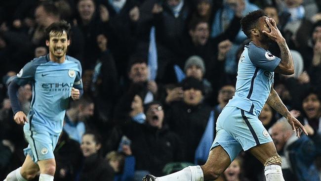 Manchester City's English midfielder Raheem Sterling (R).