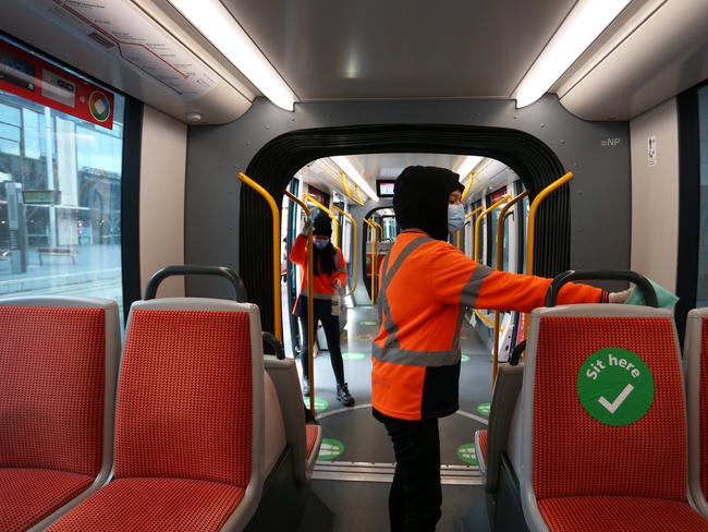 Light rail cleaners wipe down a tram in Sydney’s CBD. Picture: Getty