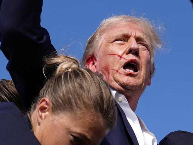 Republican presidential candidate former President Donald Trump is surrounded by U.S. Secret Service agents at a campaign rally, Saturday, July 13, 2024, in Butler, Pa. (AP Photo/Evan Vucci)