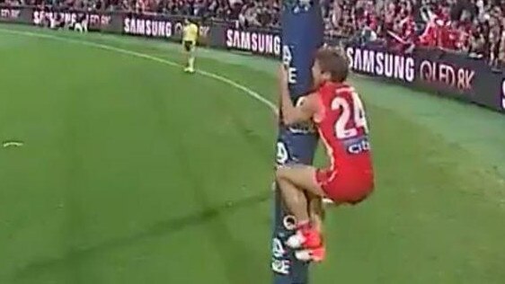 Dane Rampe shakes goalpost as David Myers prepares to take his shot after the siren.