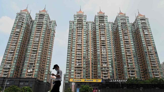 A man walks past a housing complex by Chinese property developer Evergrande in Guangzhou, China's southern Guangdong province. Picture: AFP