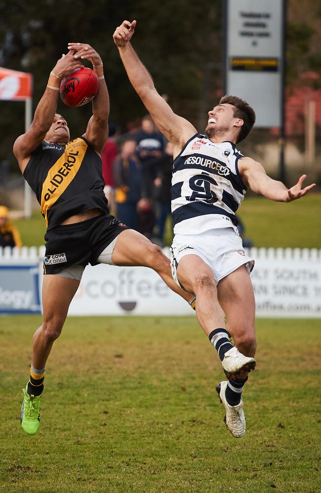 Glenelg's Dom Barry takes a mark over South's Richard Newell at Gliderol Stadium.