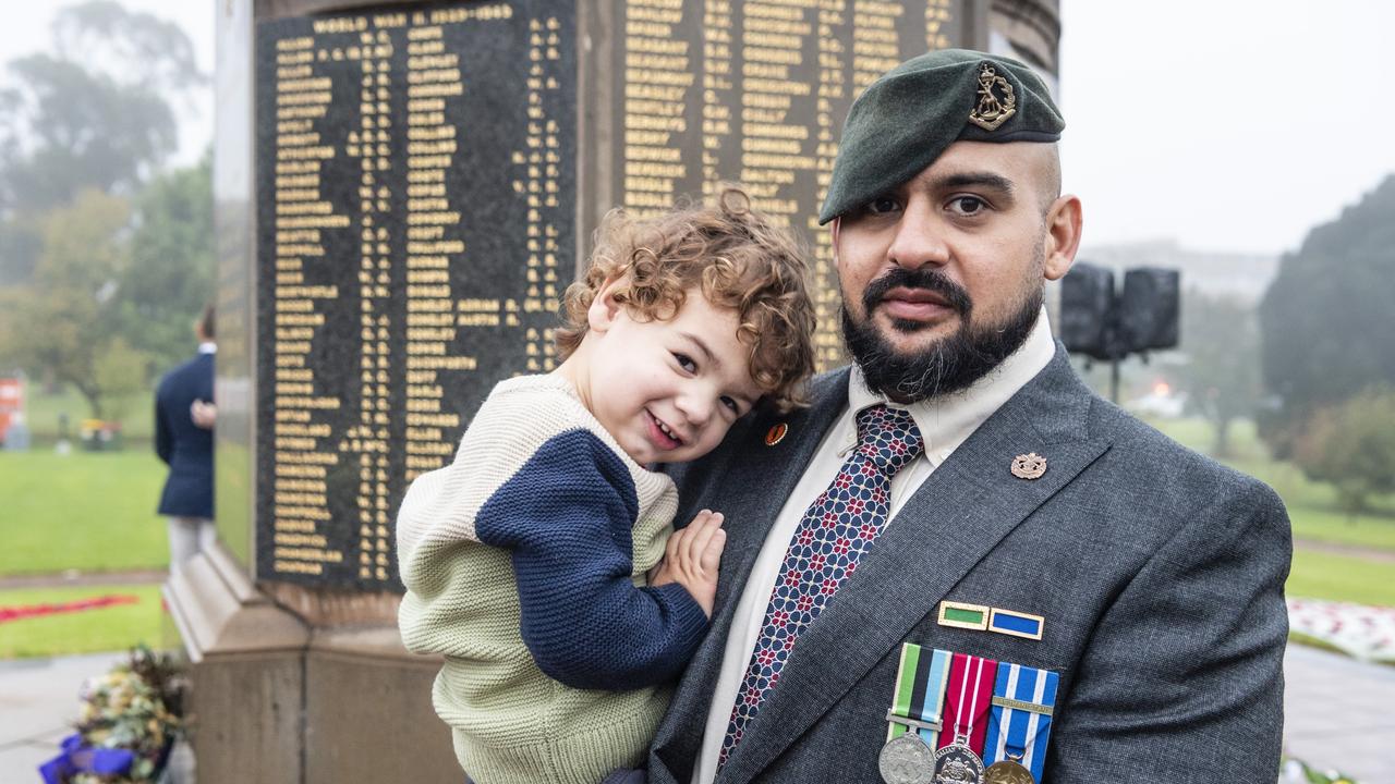 Luca Batlle with his father former 3RAR Lavarack barracks member Javier Batlle at the Mothers' Memorial after the Anzac Day dawn service, Monday, April 25, 2022. Picture: Kevin Farmer