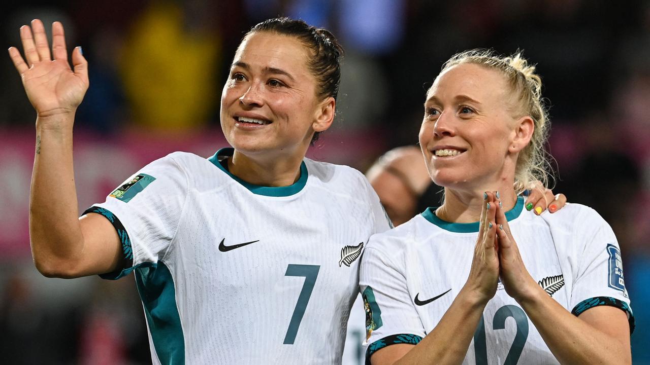 New Zealand's Ali Riley (L) and teammate Betsy Hassett salute the crowd. Picture: AFP