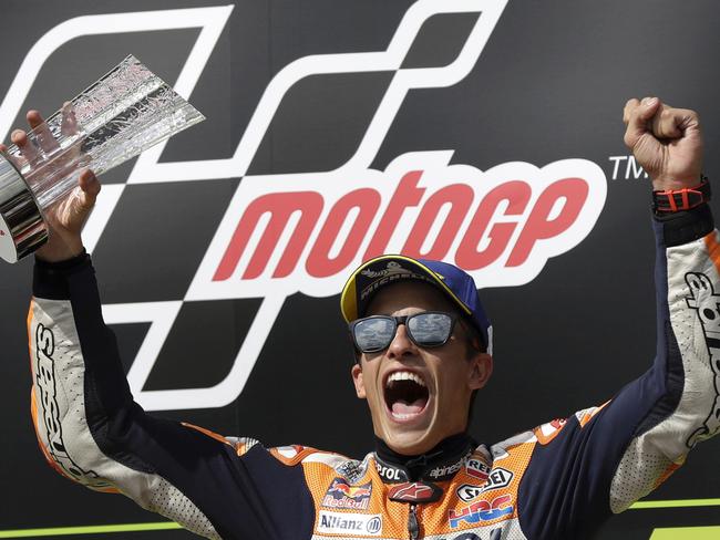 Spain's rider Marc Marquez of the Repsol Honda Team celebrates with trophy on the podium after winning the MotoGP race at the Czech Republic motorcycle Grand Prix at the Automotodrom Brno, in Brno, Czech Republic, Sunday, Aug. 4, 2019. (AP Photo/Petr David Josek)