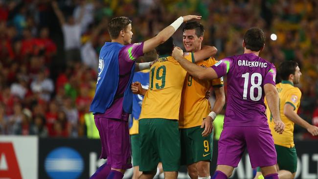 Australian players celebrate on the final whistle.