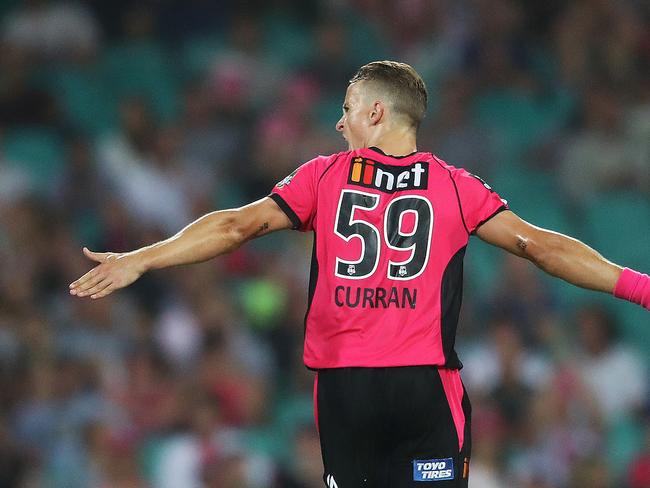 Sixers' Tom Curran celebrate's his wicket of Heat's Ben Cutting during BBL match between the Sydney Sixers and Brisbane Heat at the SCG. Picture. Phil Hillyard