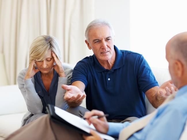 Senior couple discussing about their financial problems with their advisor