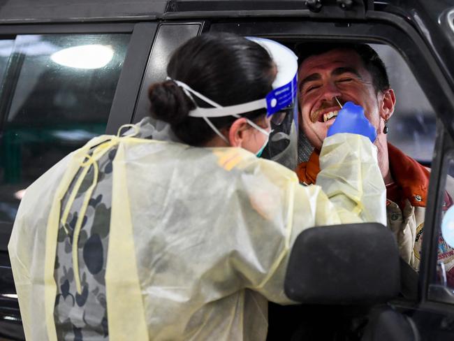 A member of the Australian Defence Force takes a swab for a COVID-19 coronavirus test on a member of the public in Melbourne.