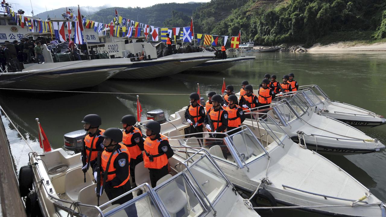 Fully-armed Chinese police officers line up on their boats as their patrol missions along the Mekong River.