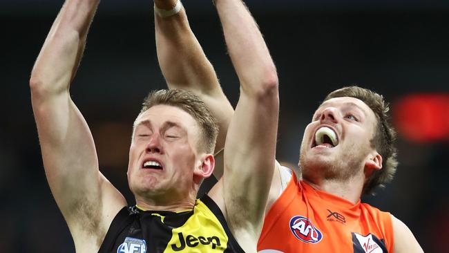 SYDNEY, AUSTRALIA – JULY 14: Callum Moore of the Tigers is challenged by Aidan Corr of the Giants during the round 17 AFL match between the Greater Western Sydney Giants and the Richmond Tigers at Spotless Stadium on July 14, 2018 in Sydney, Australia. (Photo by Matt King/Getty Images)