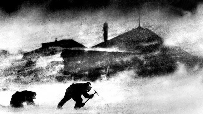 Two members of Mawson's 1912 exploration team battle a blizzard.