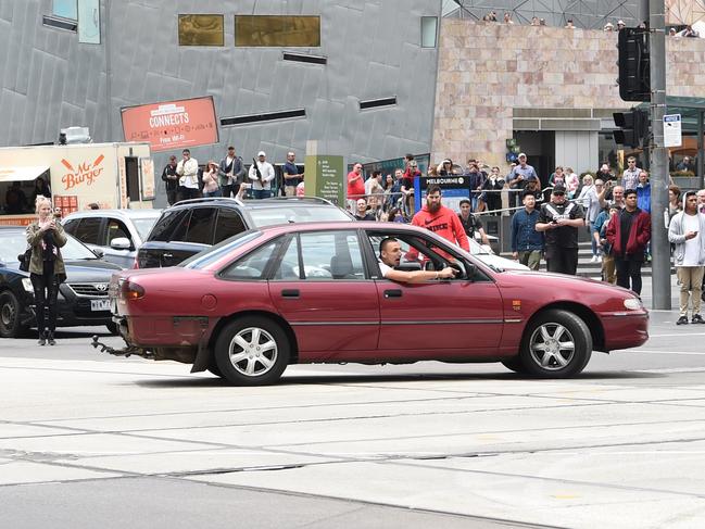 Dimitrious Gargasoulas before he cut through the lunchtime crowds in Bourke St. Picture: Tony Gough