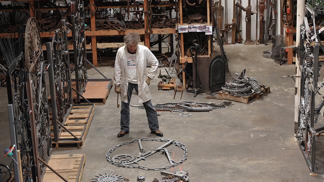 Bob Dylan working on an iron sculpture, an obsession he attributes to his upbringing in Minnesota iron-mining towns.