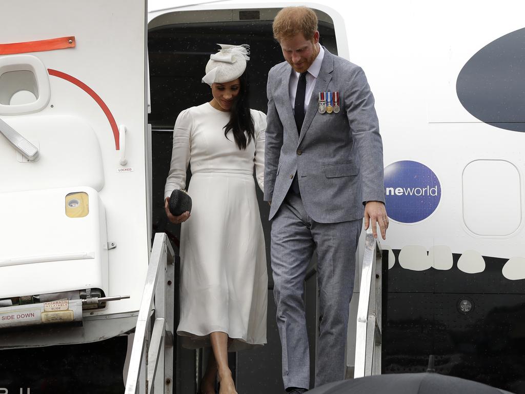 Britain's Prince Harry and Meghan, Duchess of Sussex disembark from their plane on their arrival in Fiji. Picture: Kirsty Wigglesworth/AP