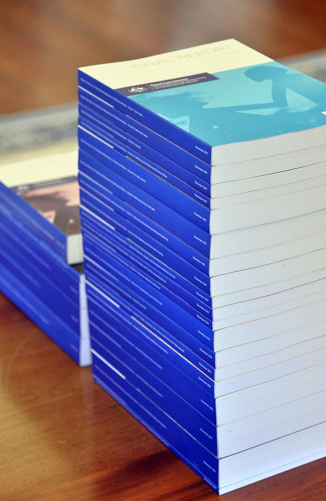 The volumes of the Final Report of the Royal Commission into Institutional Responses to Child Sexual Abuse sit on the table before the signing ceremony of the release of the papers at Government House, Canberra, 15 December, 2017. Photo: Jeremy Piper