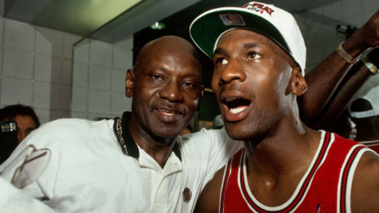 Michael Jordan celebrates an NBA playoff win with his late father, James, in 1993.