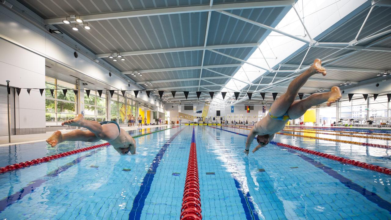 Invictus Games 2025 Team Australia competitors Jake Christie (left) and Callan McLean dive in to the pool for a time trial as part of a training camp held at the Australian Institute of Sport, in Canberra.