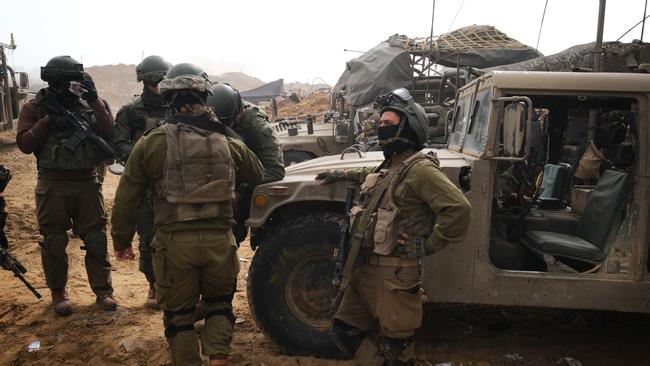 Soldiers outside a school once used by Hamas in Khan Younis. Picture: Yoni Bashan / The Australian