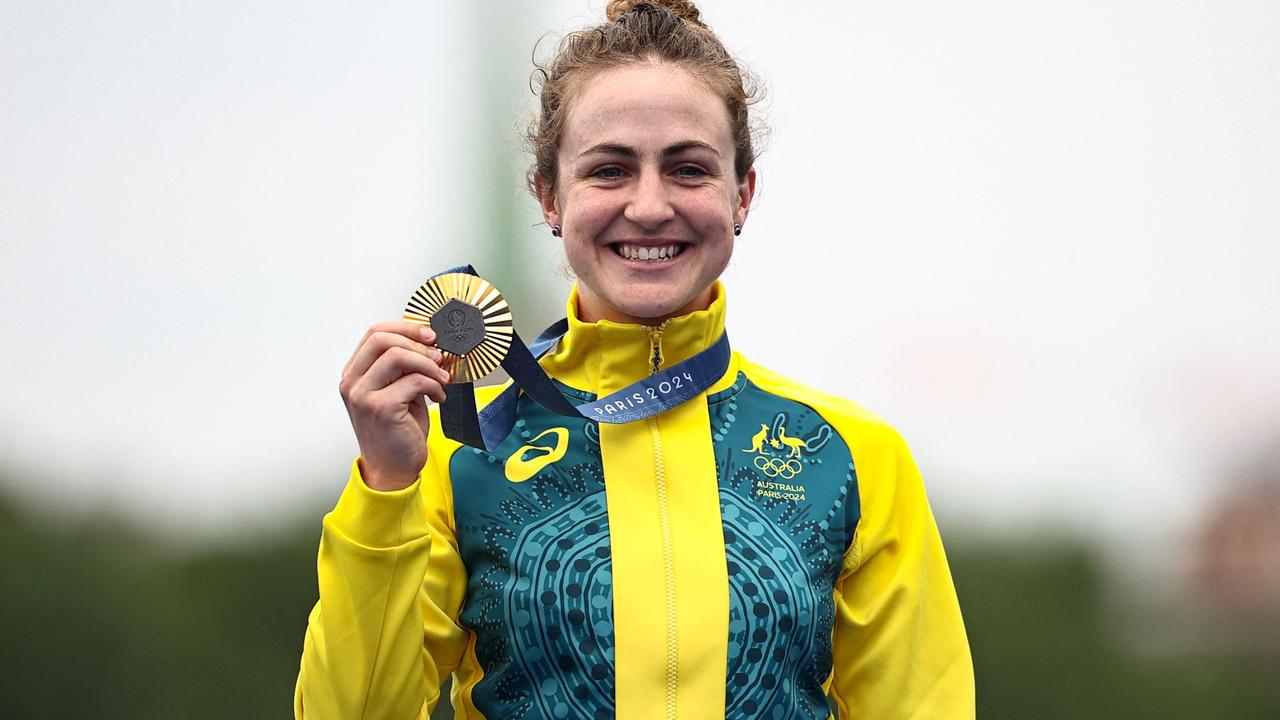 Australia's Grace Brown shows off Australia’s first gold of the Games. Picture: Anne-Christine Poujoulat / AFP