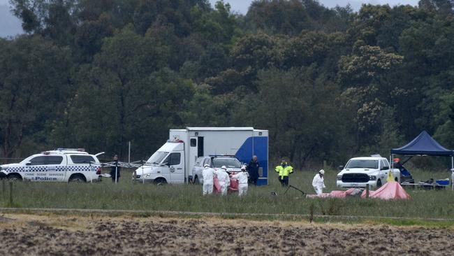 Police investigate the scene of a light plane crash near Tinamba West which killed the three occupants. Picture: Andrew Henshaw