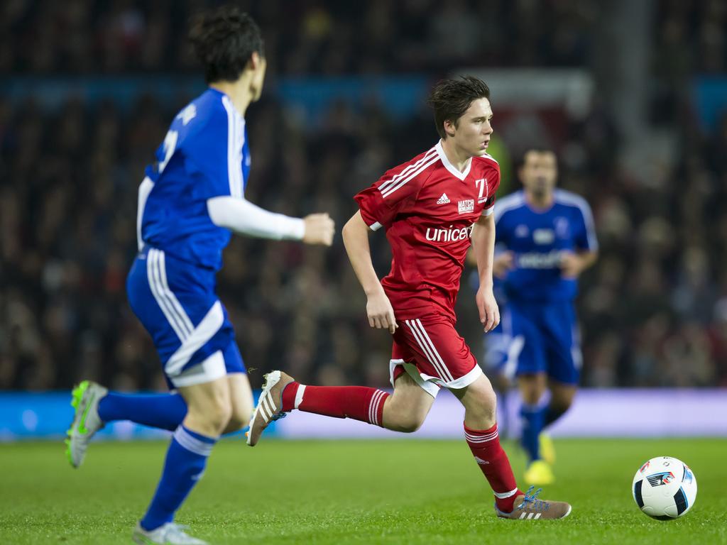 Great Britain and Ireland’s Brooklyn Beckham, right, takes the ball downfield during the Unicef Match for Children charity football match between a Great Britain and Ireland team and a Rest of the World team at Old Trafford Stadium, Manchester on November 14, 2015. Picture: AP