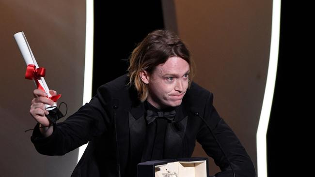 US actor Caleb Landry Jones delivers a speech on stage after he won the Best Actor Prize for his part in "Nitram" at the 74th edition of the Cannes Film Festival in Cannes, southern France, on July 17, 2021. (Photo by CHRISTOPHE SIMON / AFP)