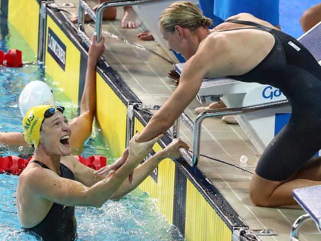 Brutal display: Cate Campbell (left) celebrates a team victory and a world record in the women's 4x100m freestyle relay final. Picture: Getty Images