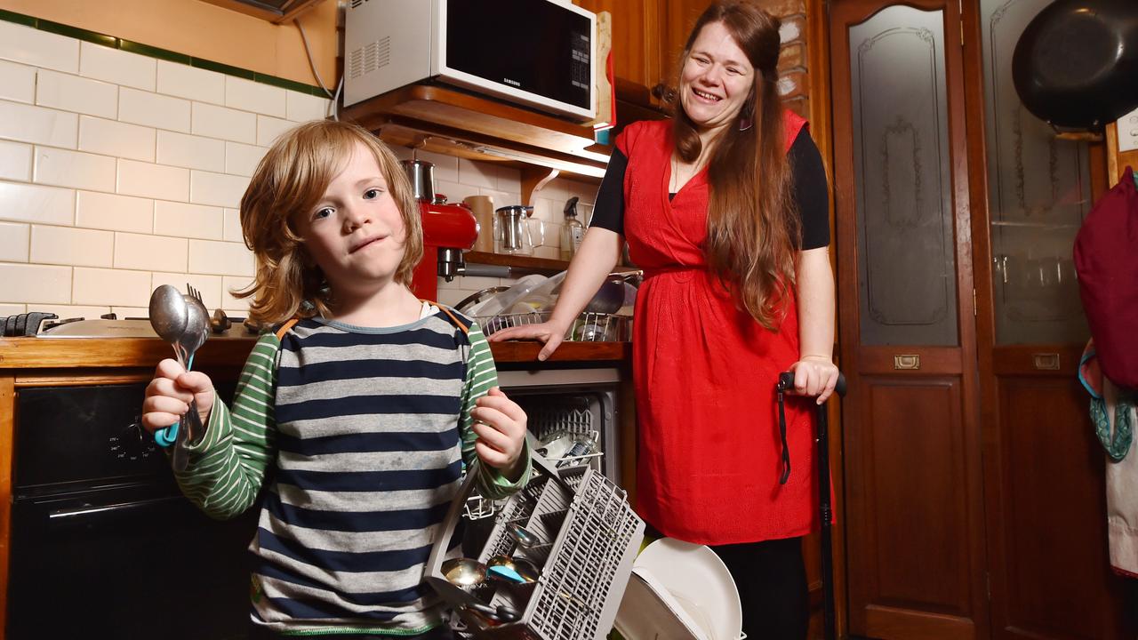 Griffin, 6, helps his mum Caitlin Williams unpack the dishwasher, as a new study suggests household chores may give kids’ brains a boost. Picture: Nicki Connolly