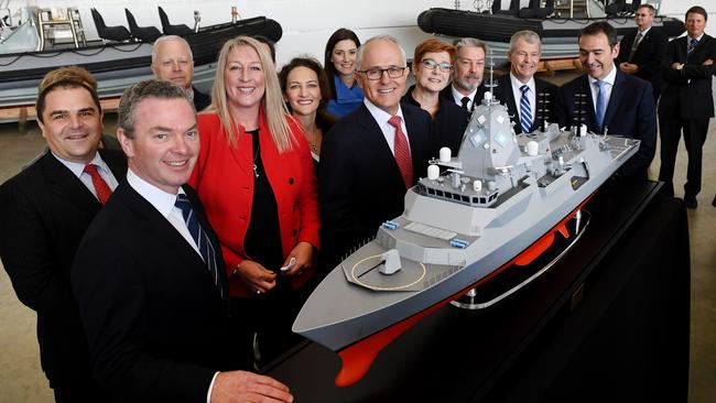 Former PM Malcolm Turnbull (centre), Defence Minister Christopher Pyne (left), BAE head Gabby Costigan (third left) and Navy personnel with a model of the new Hunter Class Frigate. Picture: AAP / Mark Brake