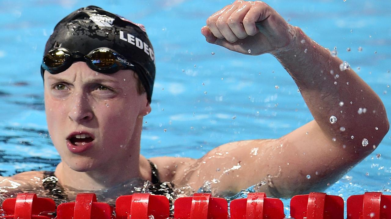 US Katie Ledecky celebrates after setting a new world record and winning the final of the women's 1500m freestyle swimming event at the 2015 FINA World Championships in Kazan on August 4, 2015. AFP PHOTO / MARTIN BUREAU