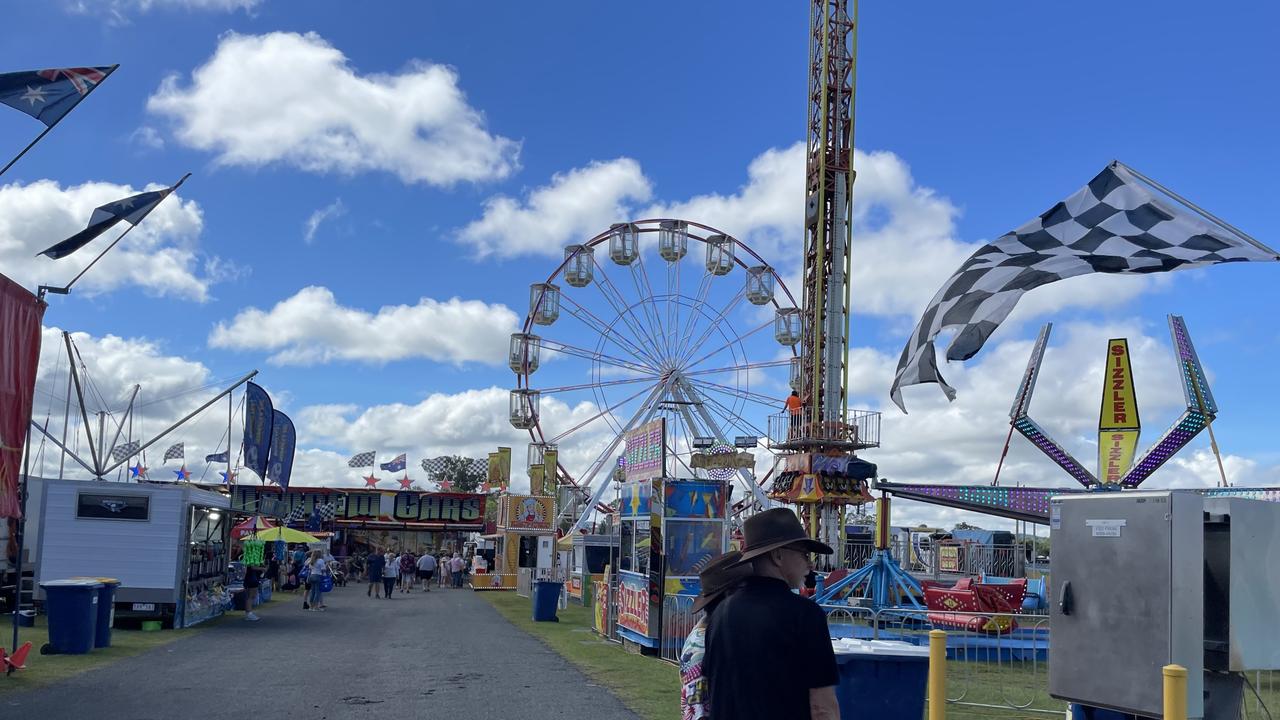 Couple in front of wheel at the Gympie Show 2025.
