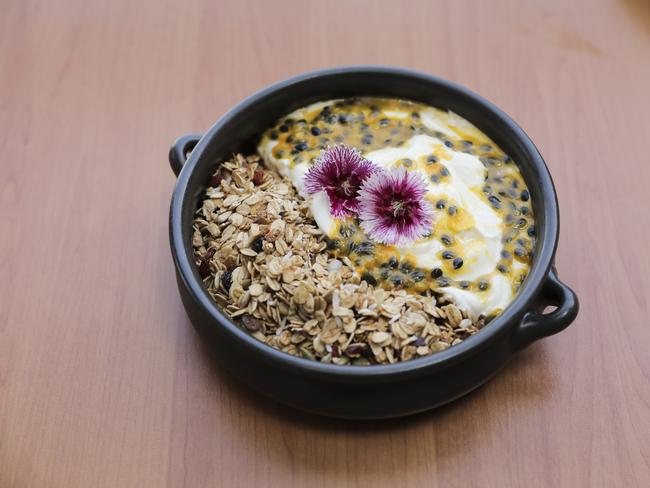 The house-made granola is a lovely mix of cinnamon-dusted oats with goji berries, almonds, sunflower seeds, pepitas and currants between waves of thick, Greek yoghurt and tart fresh passionfruit. Picture: Mark Cranitch