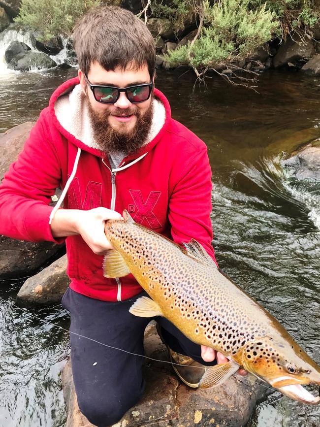 Alistair Smythe with a beaut brown trout he caught late last season in the South of the state. Picture: SUPPLIED