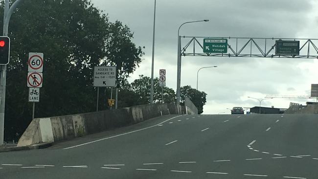 Sandgate Rd leading to the entrance for the Nundah Tunnel with (centre) a sign showing cyclists and pedestrians are prohibited from entering.