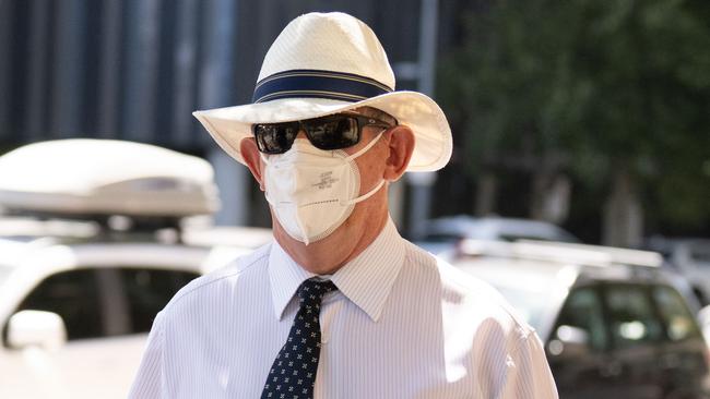 Warland covers his face as he leaves court after an earlier appearance. Picture: NCA NewsWire / Morgan Sette