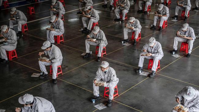 Social distancing at lunch in the Honda factory in the Chinese city of Wuhan, the epicentre of the coronavirus, on Monday. Picture: AFP